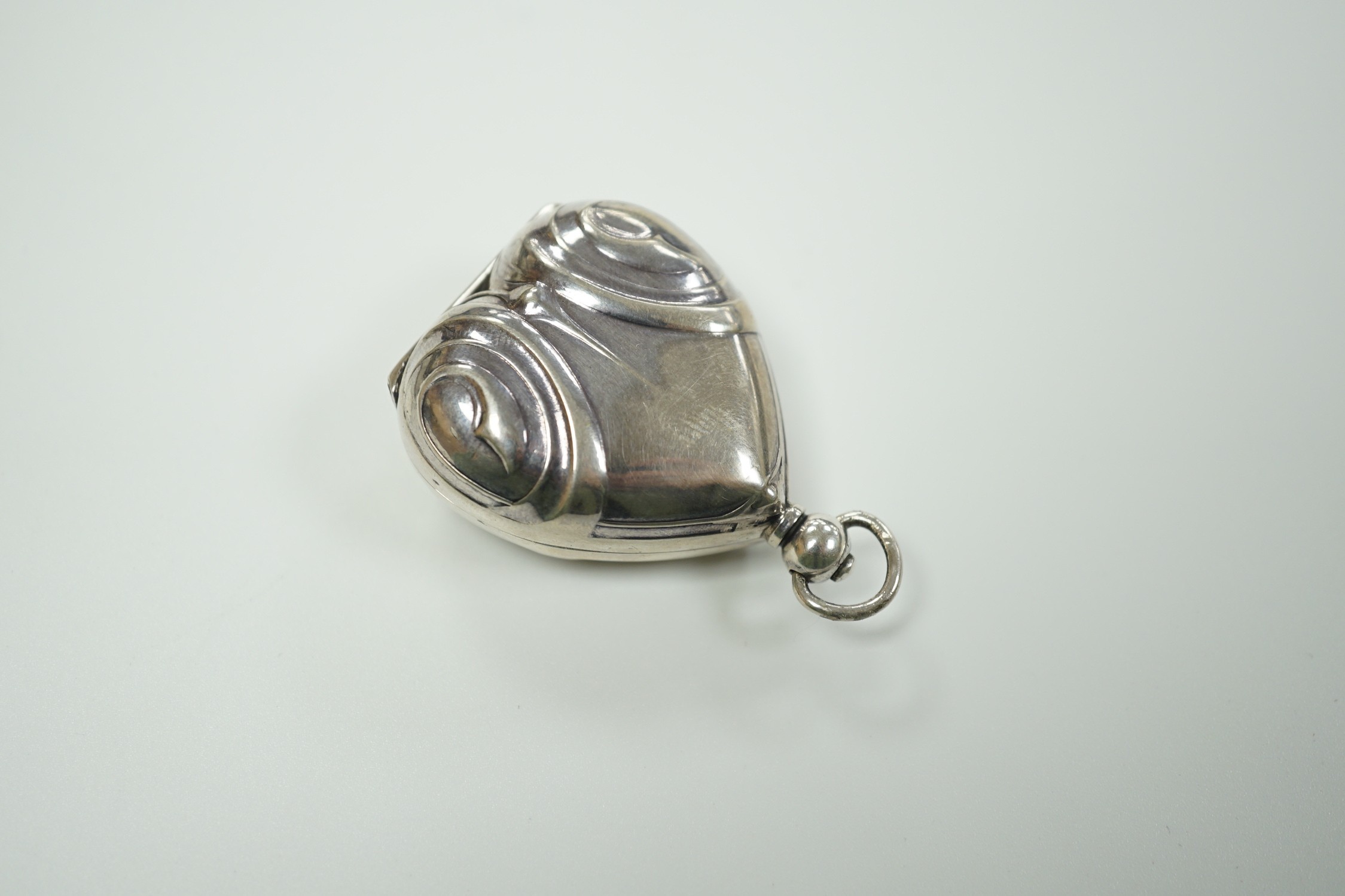 A French? white metal heart shaped gold 20 francs? case, overall 49mm.